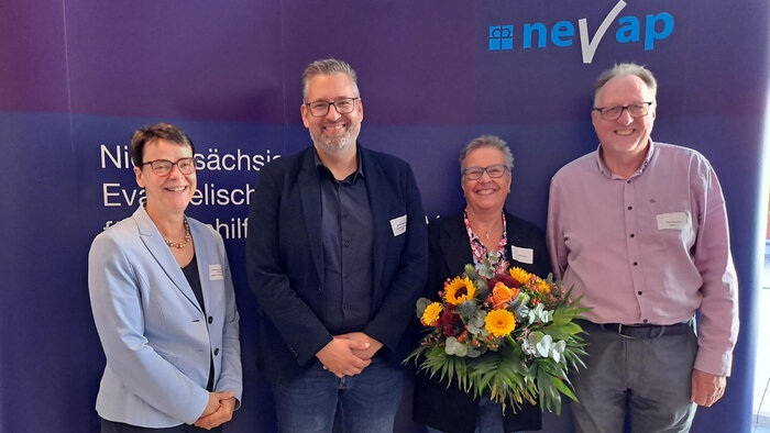 Vier Personen vor einer violetten Wand
